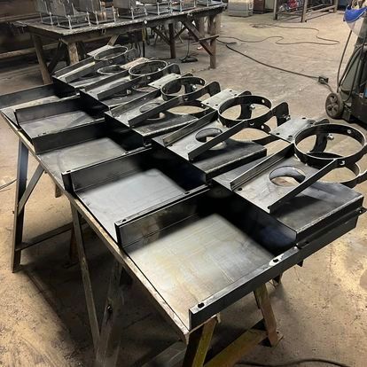 A bunch of metal pieces are sitting on top of a table.