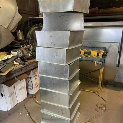 A stack of metal boxes sitting on top of each other in a room.