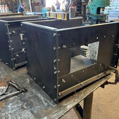 A couple of metal boxes are sitting on top of a table.