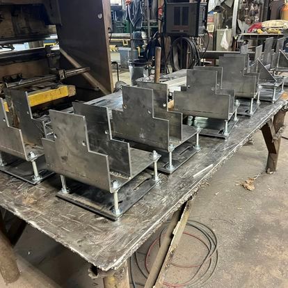 A table with a bunch of metal pieces on it.