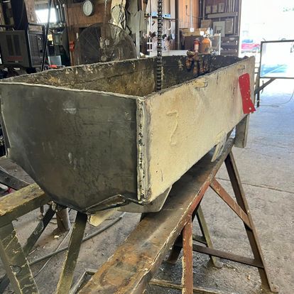 A large metal box is sitting on top of a wooden table.