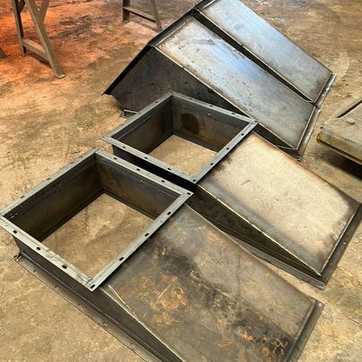 A bunch of metal boxes are sitting on top of each other on the floor.