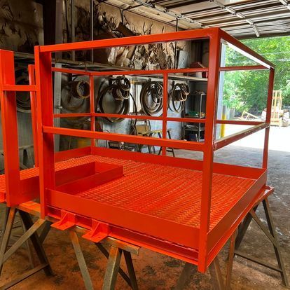 A red cage is sitting on top of a wooden table.