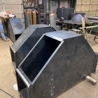 A man is working on a piece of metal in a factory.