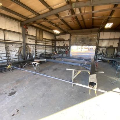 A large metal structure is being built in a garage.