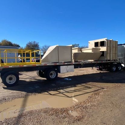 A trailer with a yellow railing attached to it