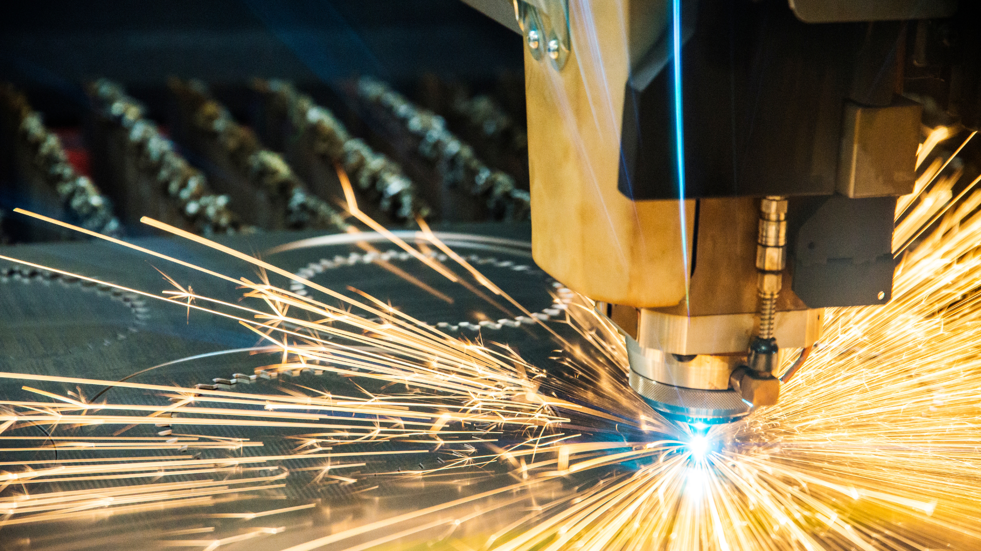 A machine is cutting a piece of metal with sparks coming out of it.