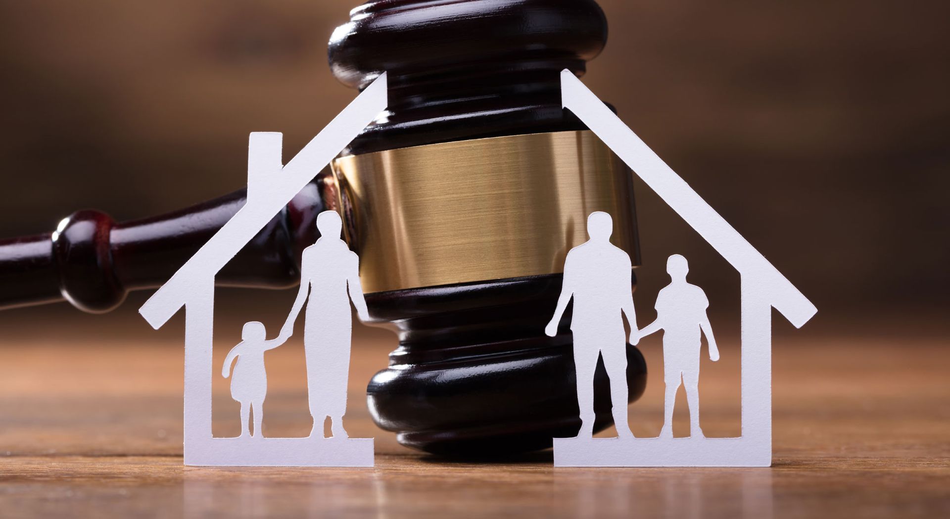 close up of law gavel and cutout of family split in half