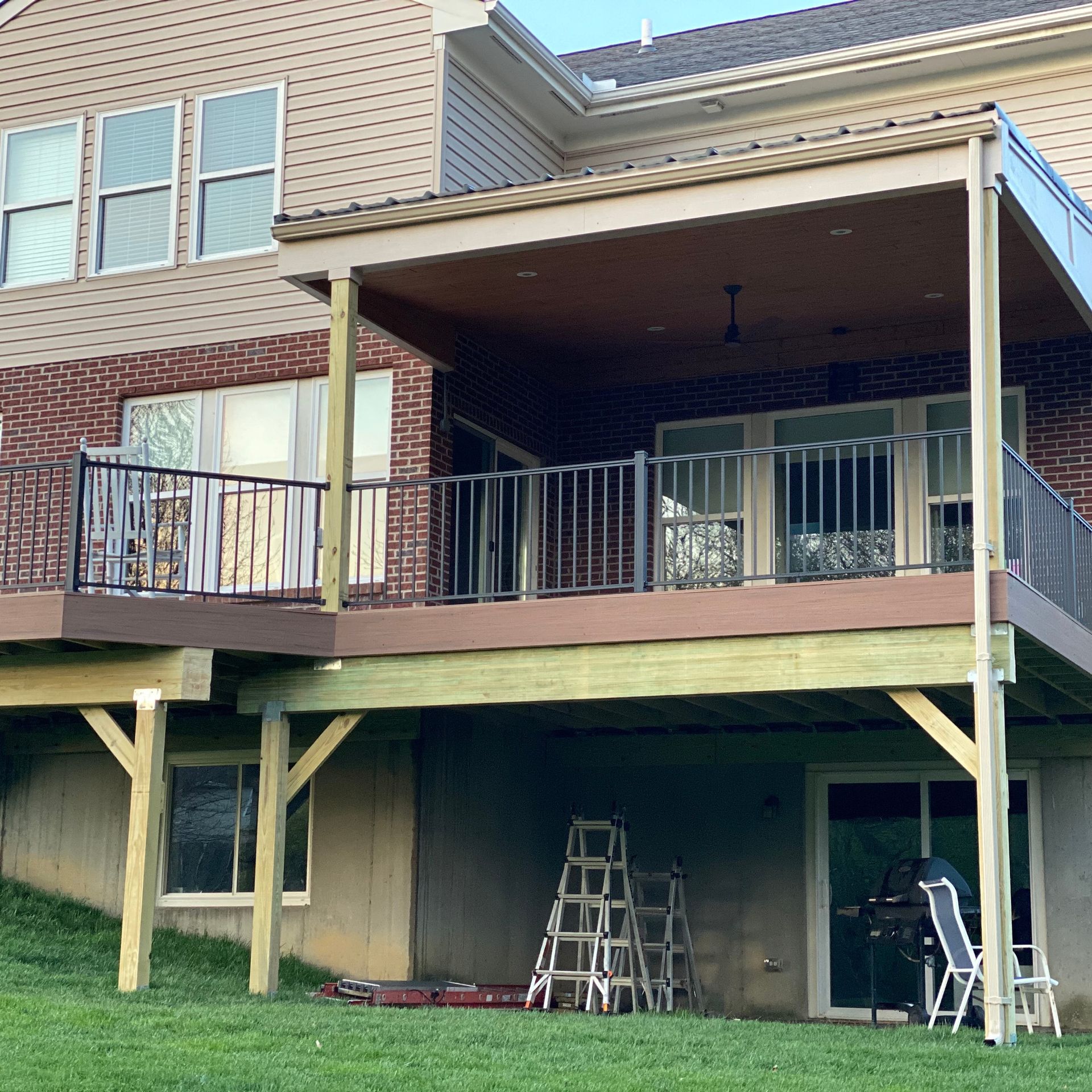 A large brick house with a large wooden deck
