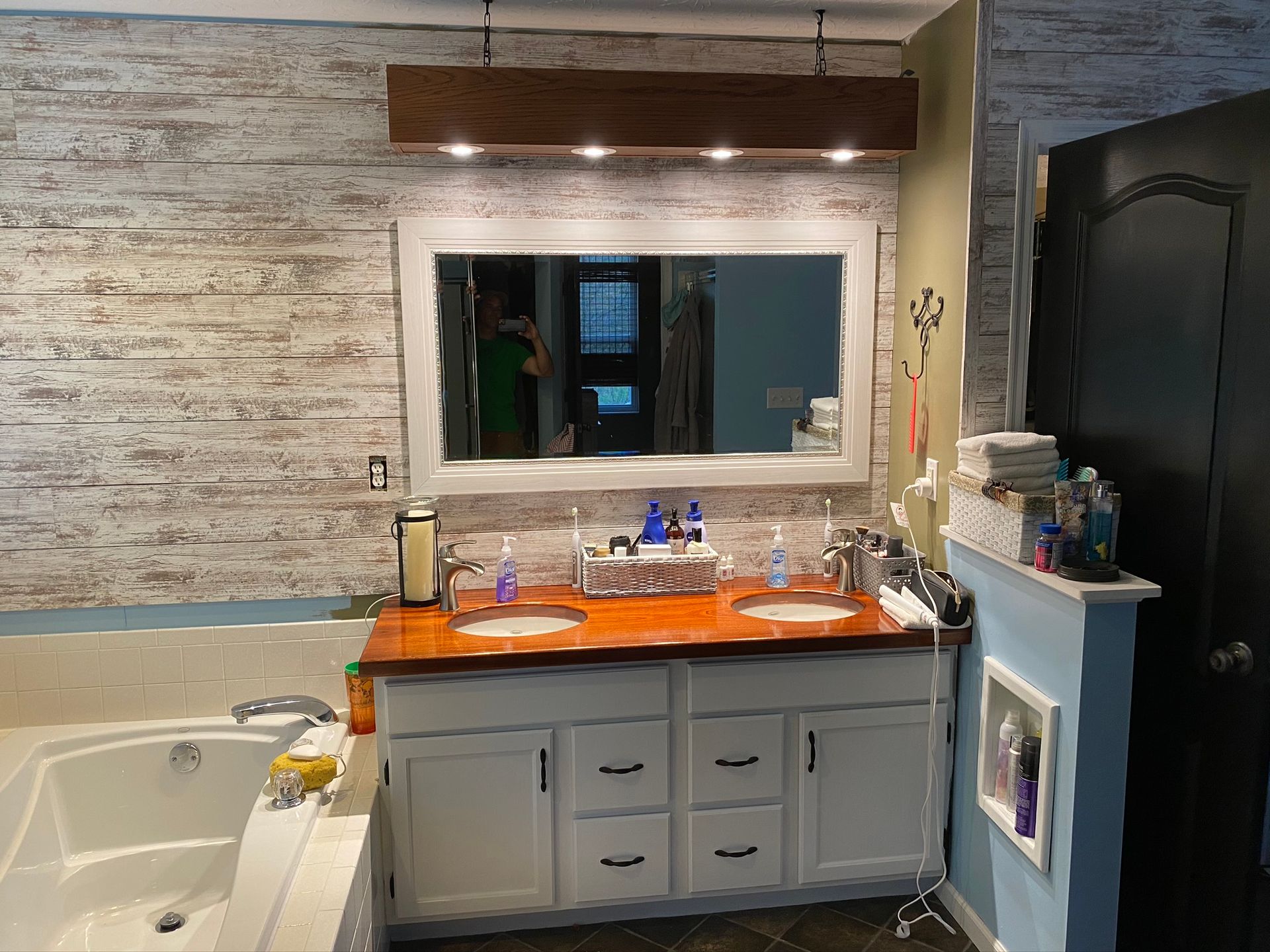 A bathroom with two sinks and a mirror with the words after on the bottom