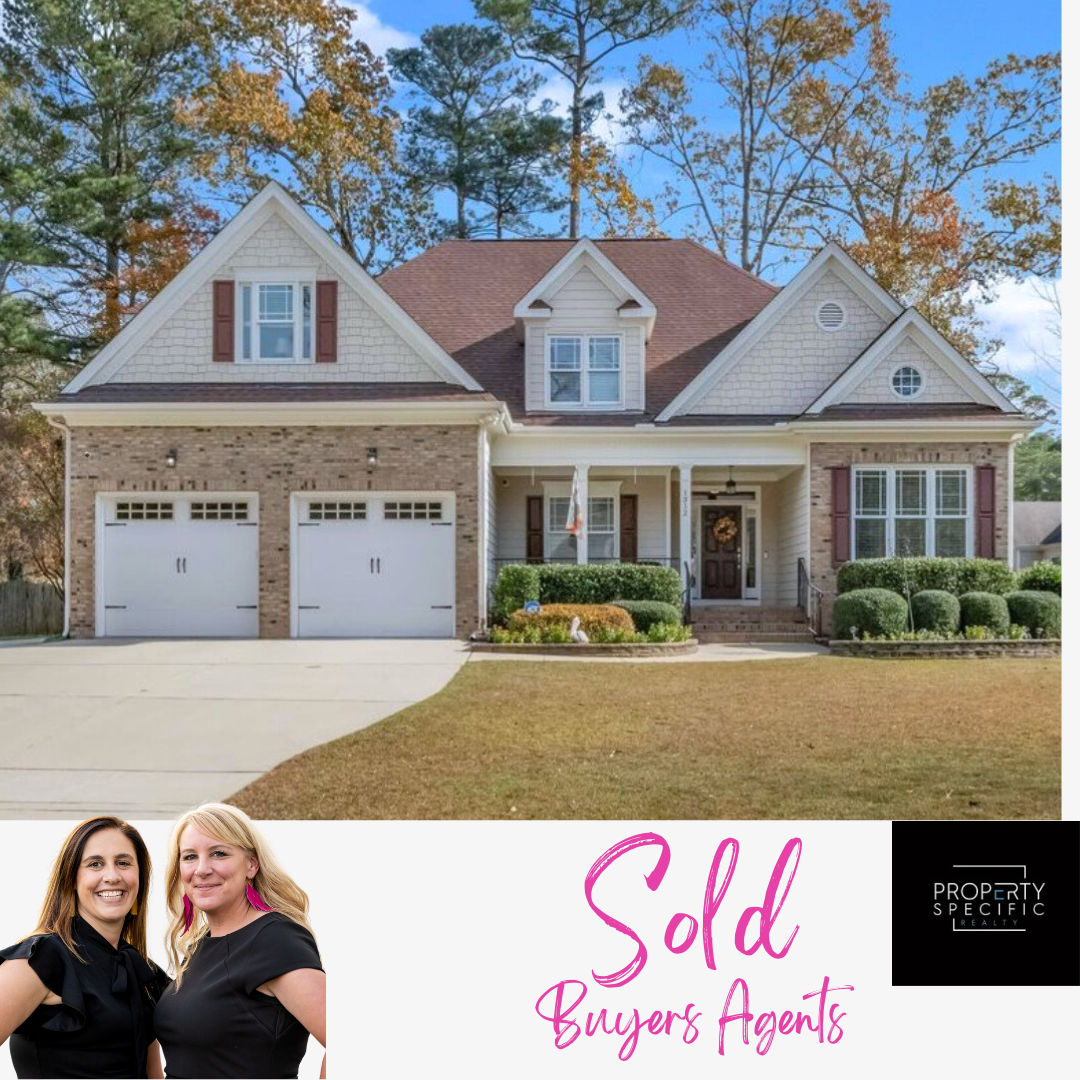 A two-story house with a tan and brick facade.