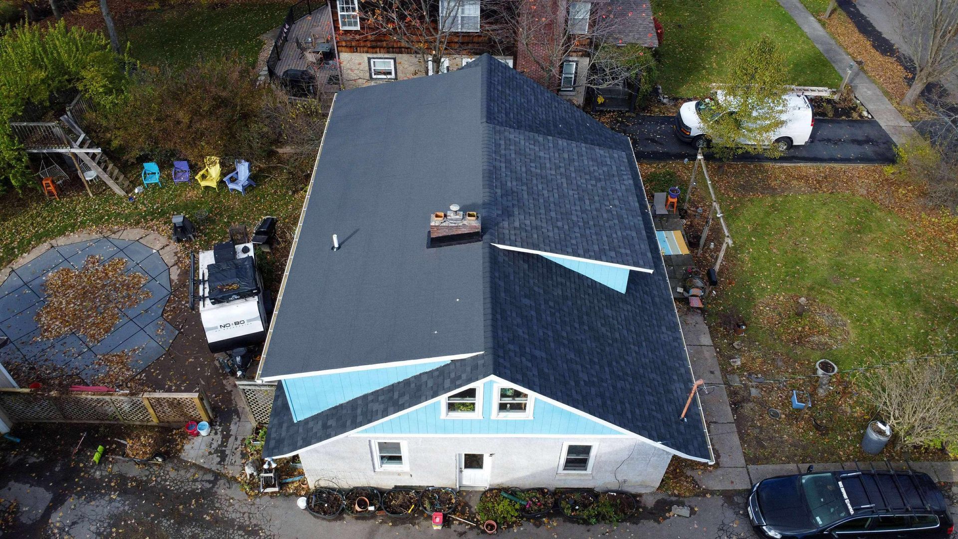 An aerial view of a house with a blue roof