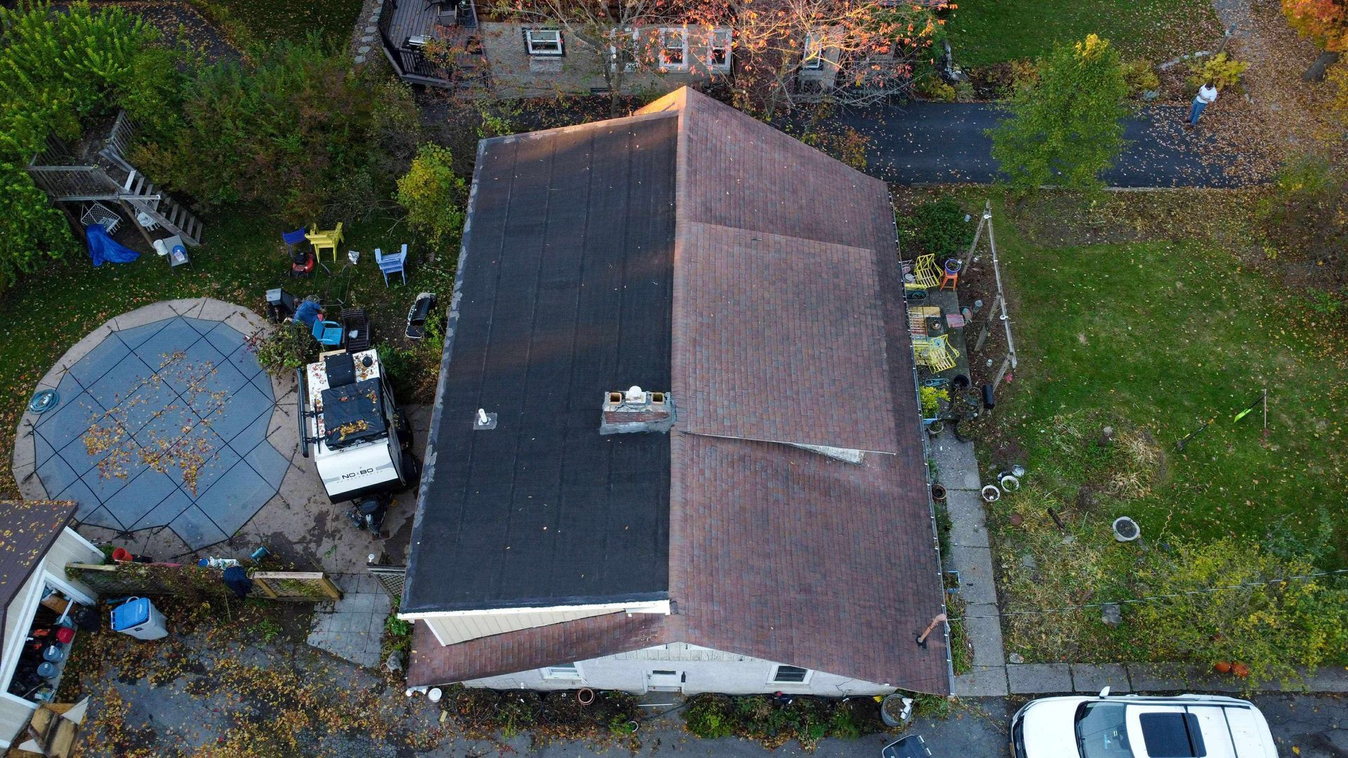 A white van is parked in front of a house
