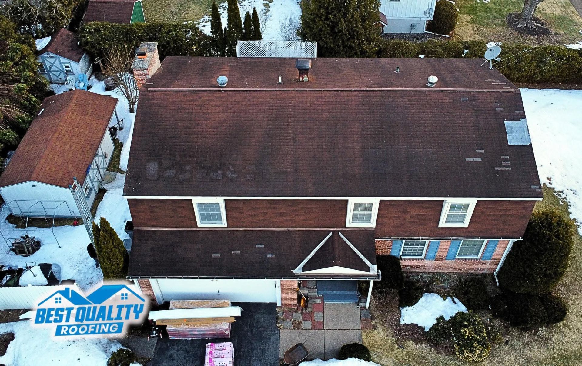 An aerial view of a house with an old roof
