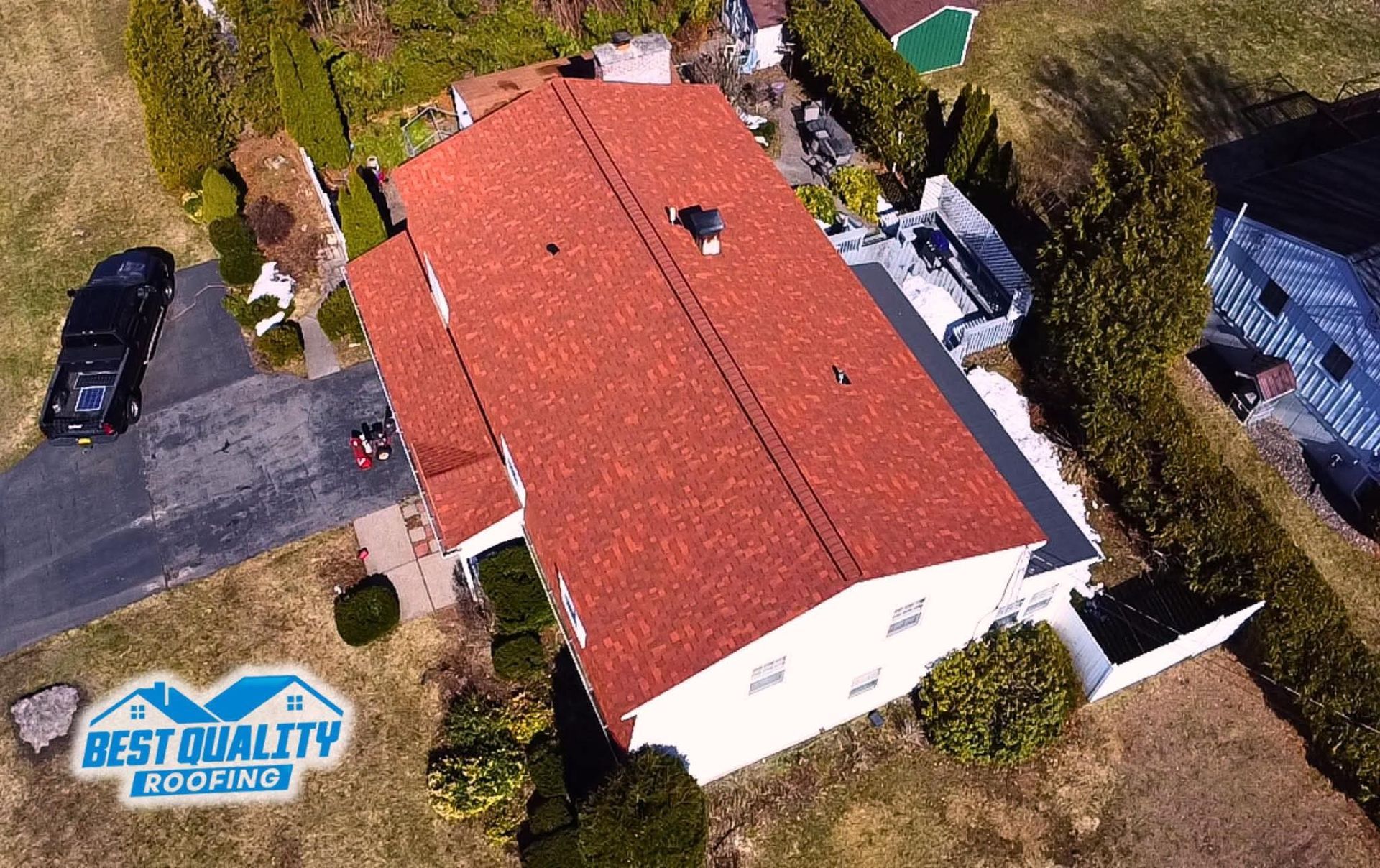 An aerial view of a house with a red roof