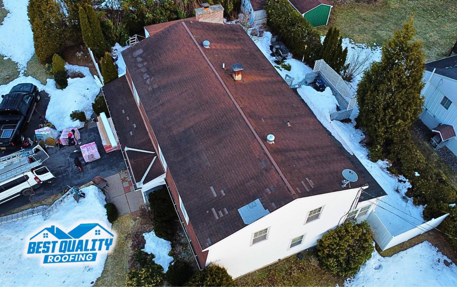 An aerial view of a house with a best quality logo on it