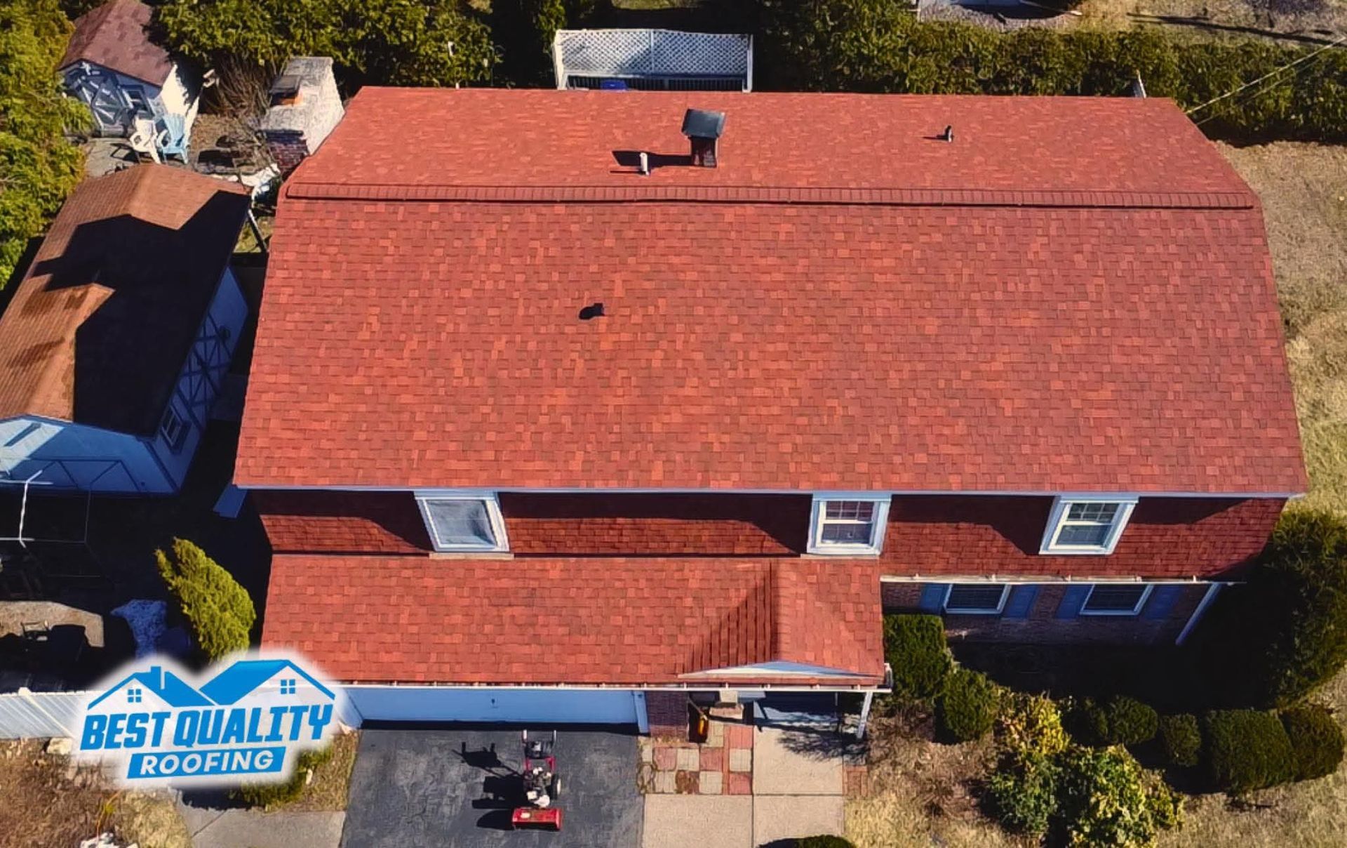 An aerial view of a house with a new red roof