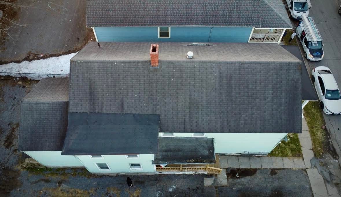 An aerial view of a house with a chimney on the roof