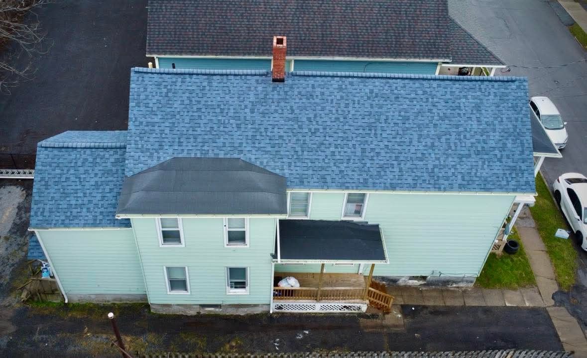 An aerial view of a house with a blue roof