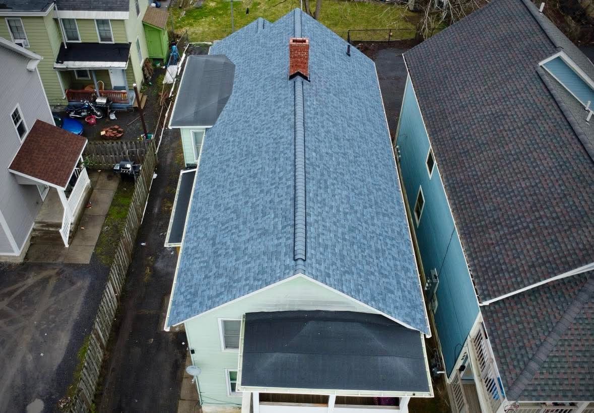 An aerial view of a house with a blue roof