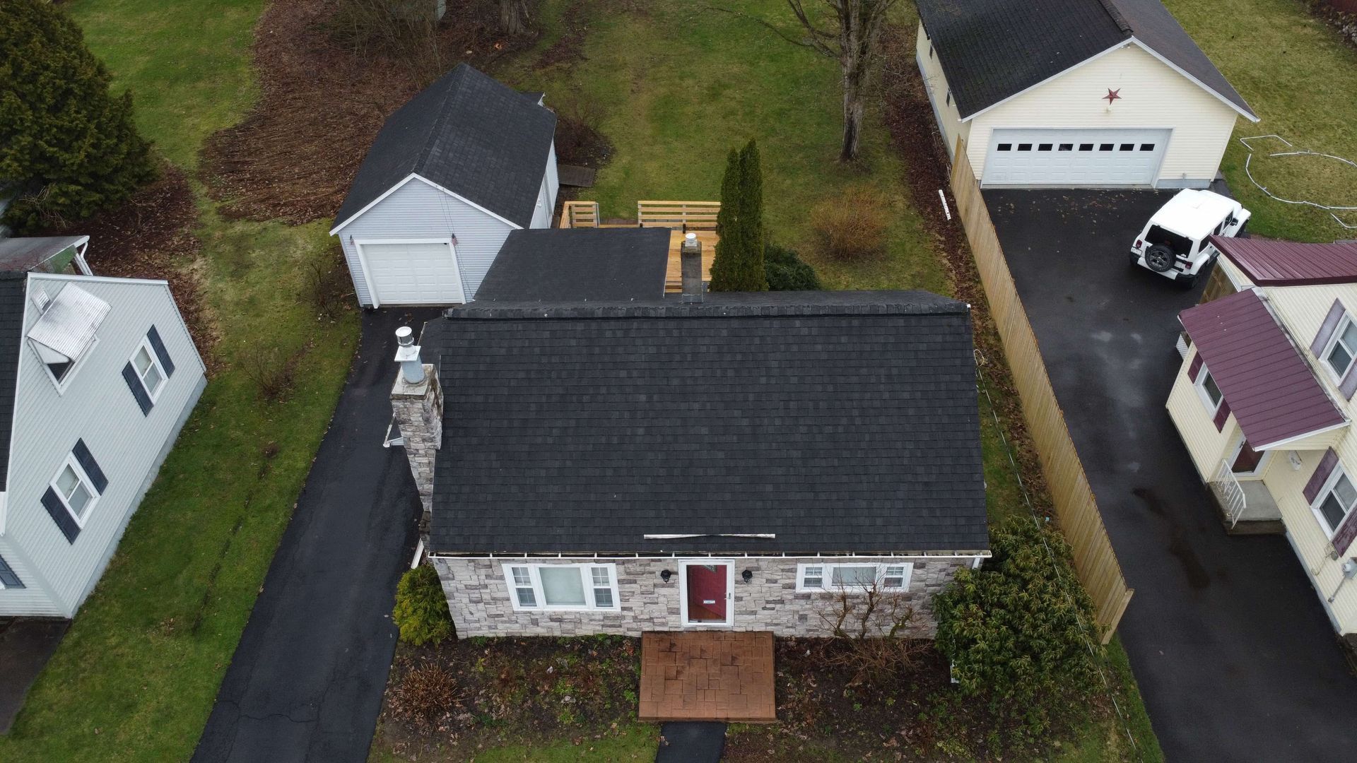 An aerial view of a house with a black roof