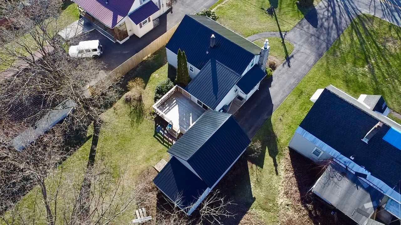 An aerial view of a residential area with houses and trees