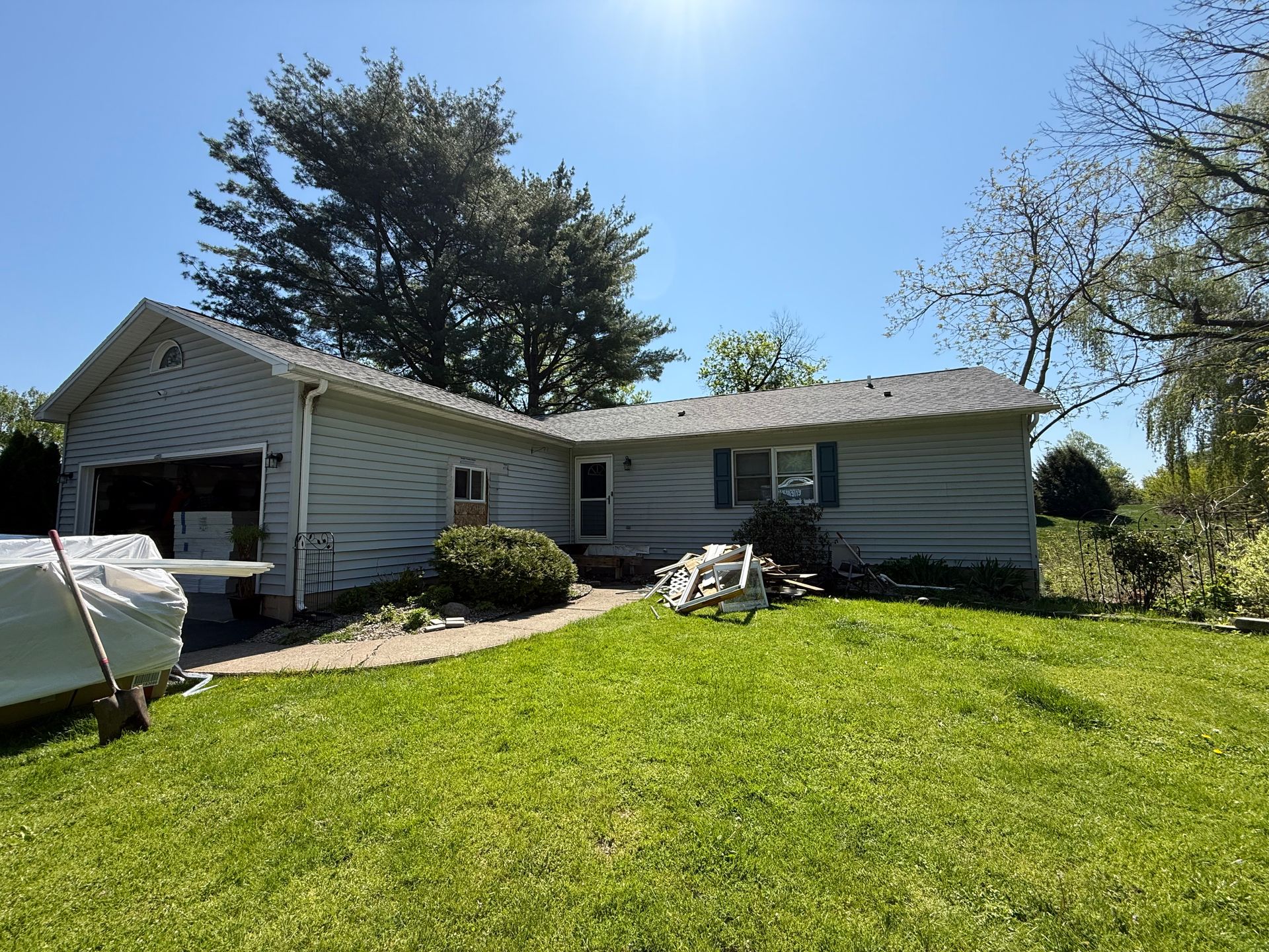A white house with a large lawn in front of it