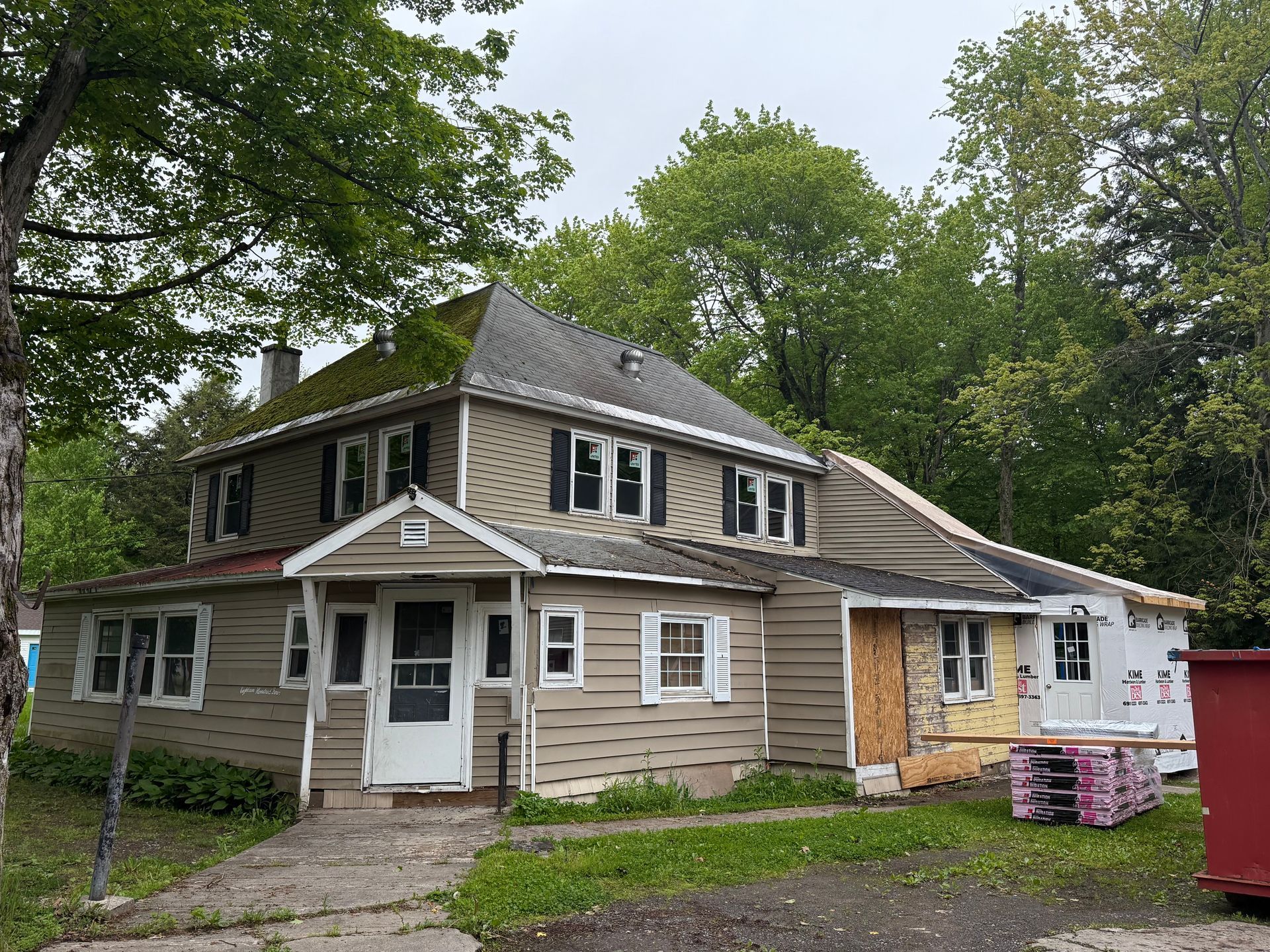 A large house with a lot of windows is being remodeled