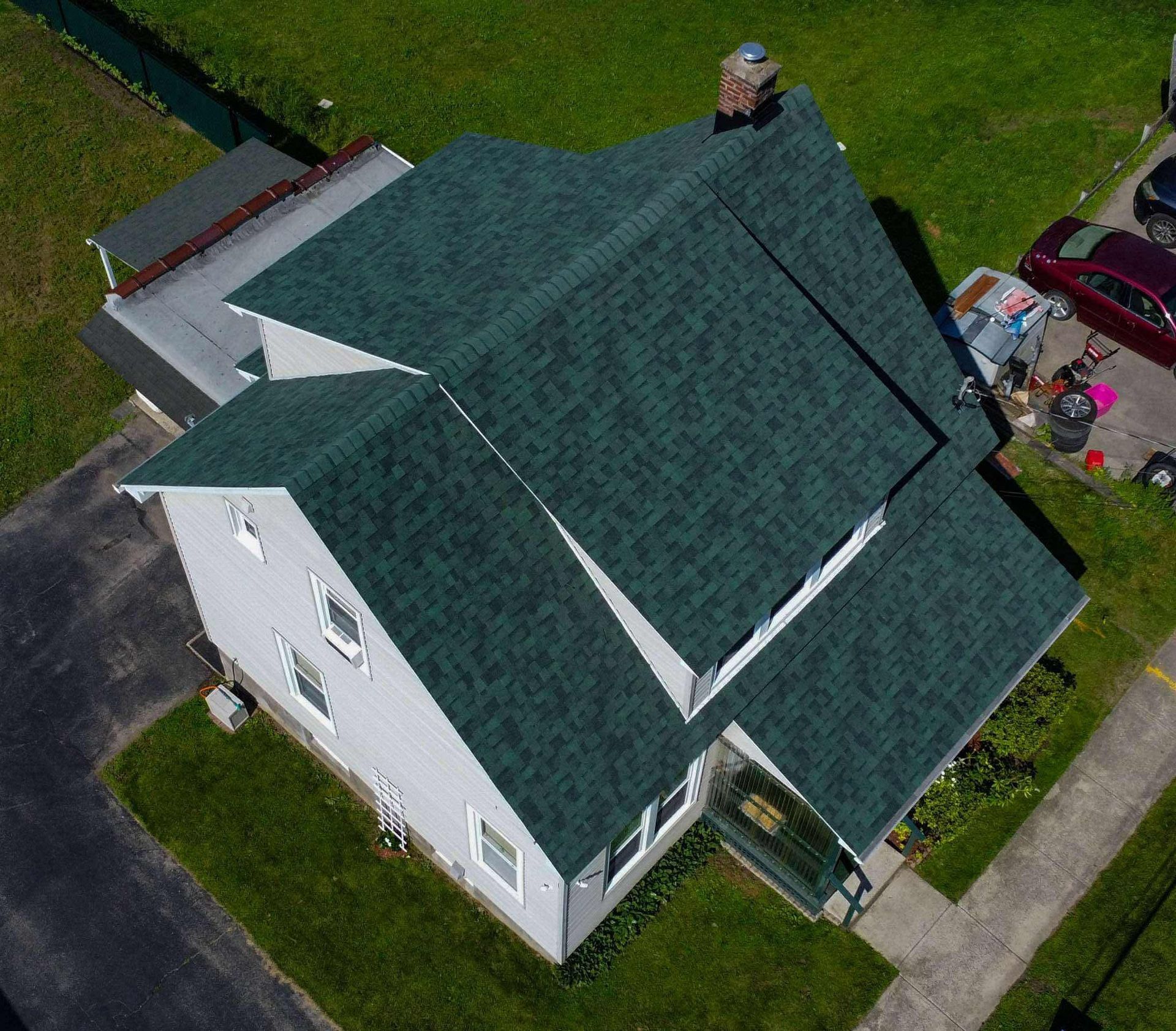 An aerial view of a house with a green roof