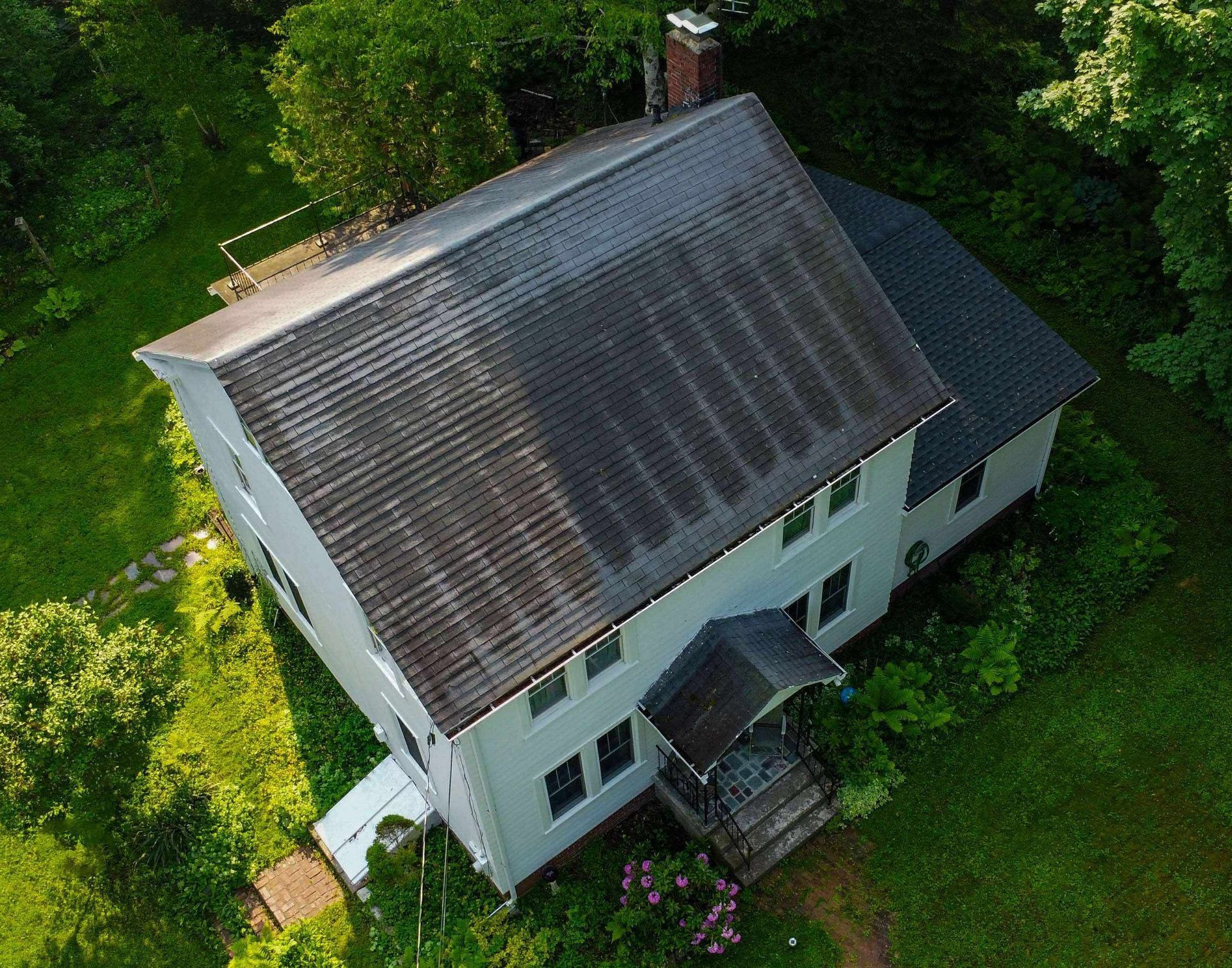 An aerial view of a house with solar panels on the roof