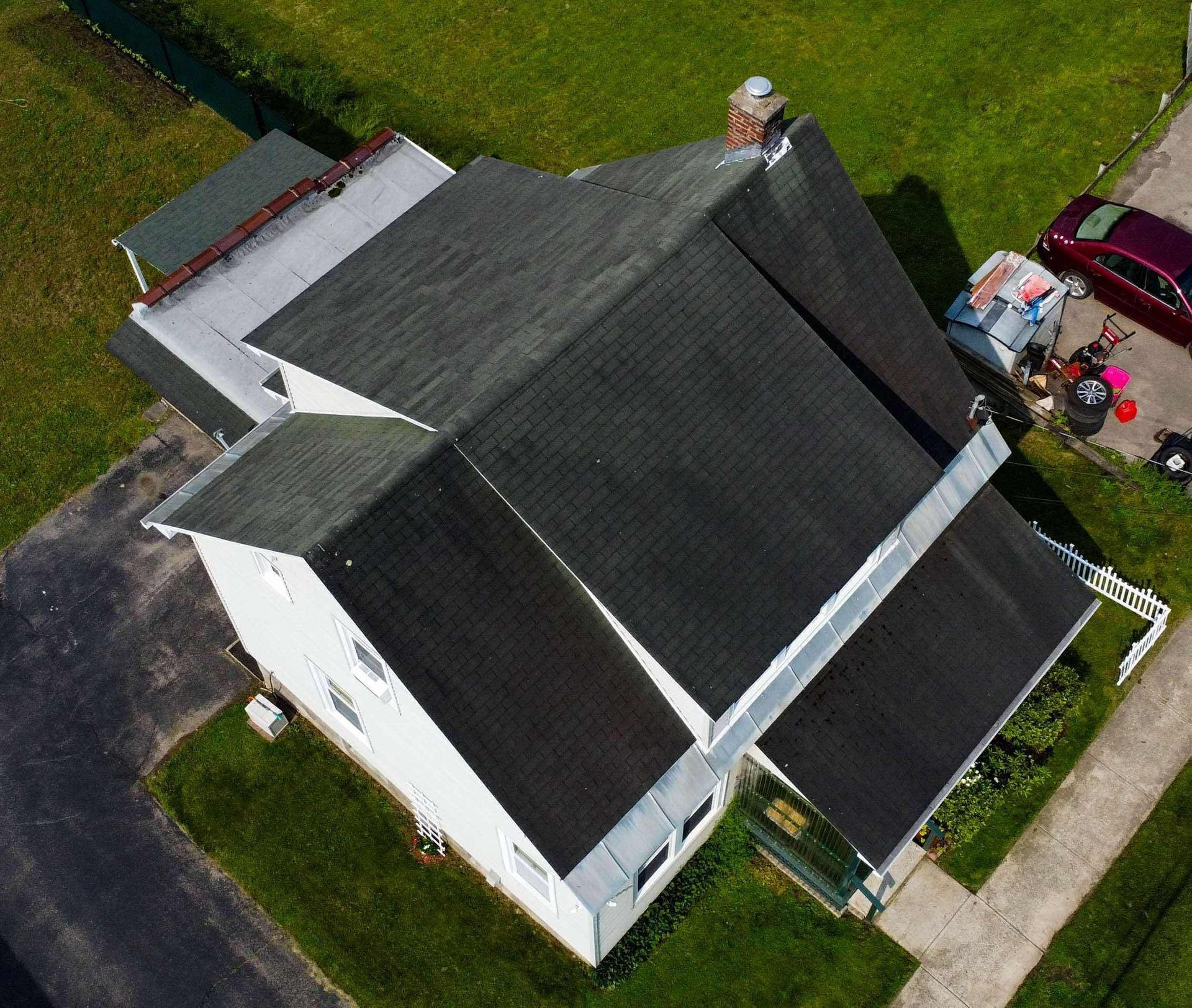 An aerial view of a house with a black roof