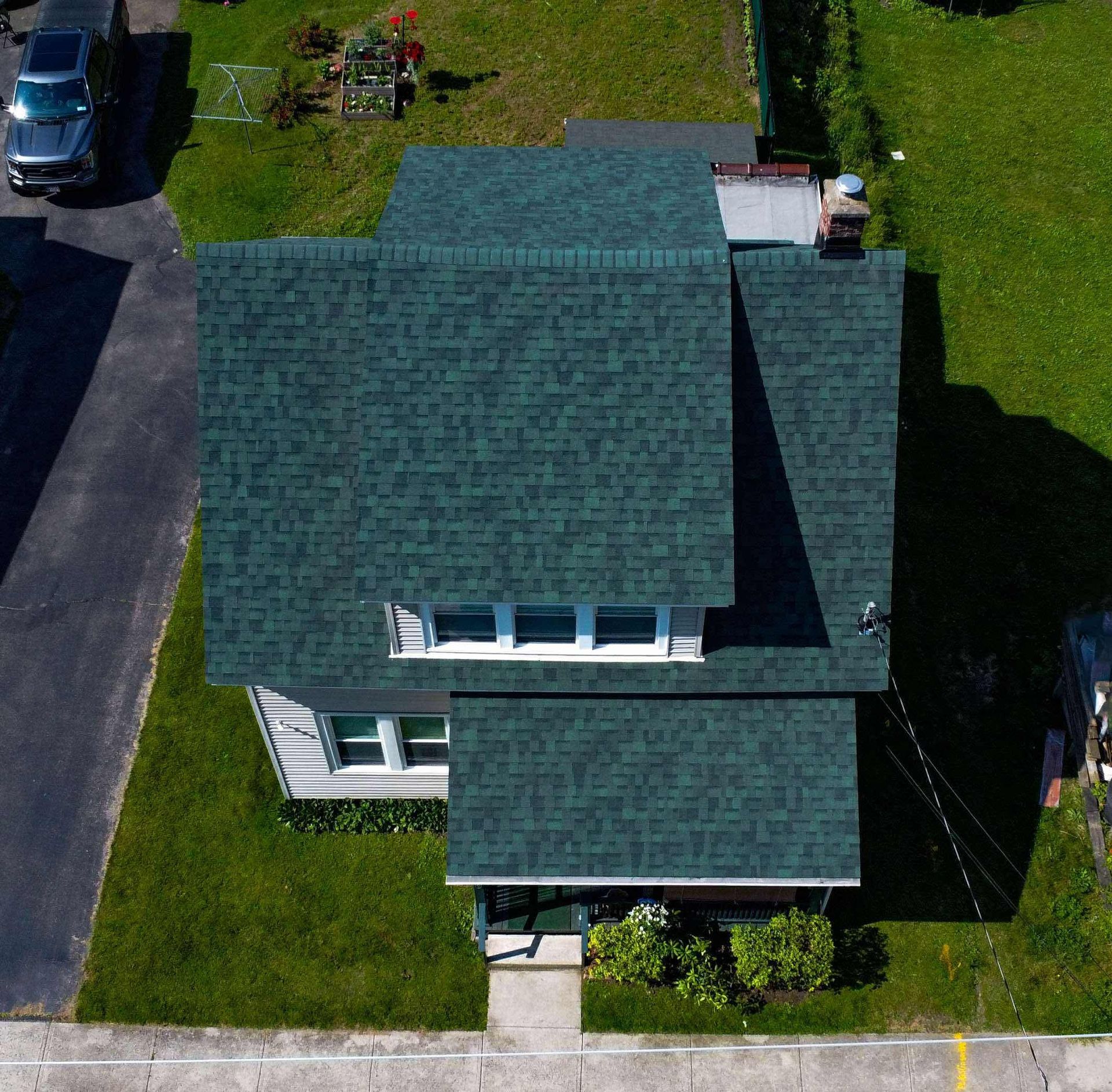 An aerial view of a house with a blue roof