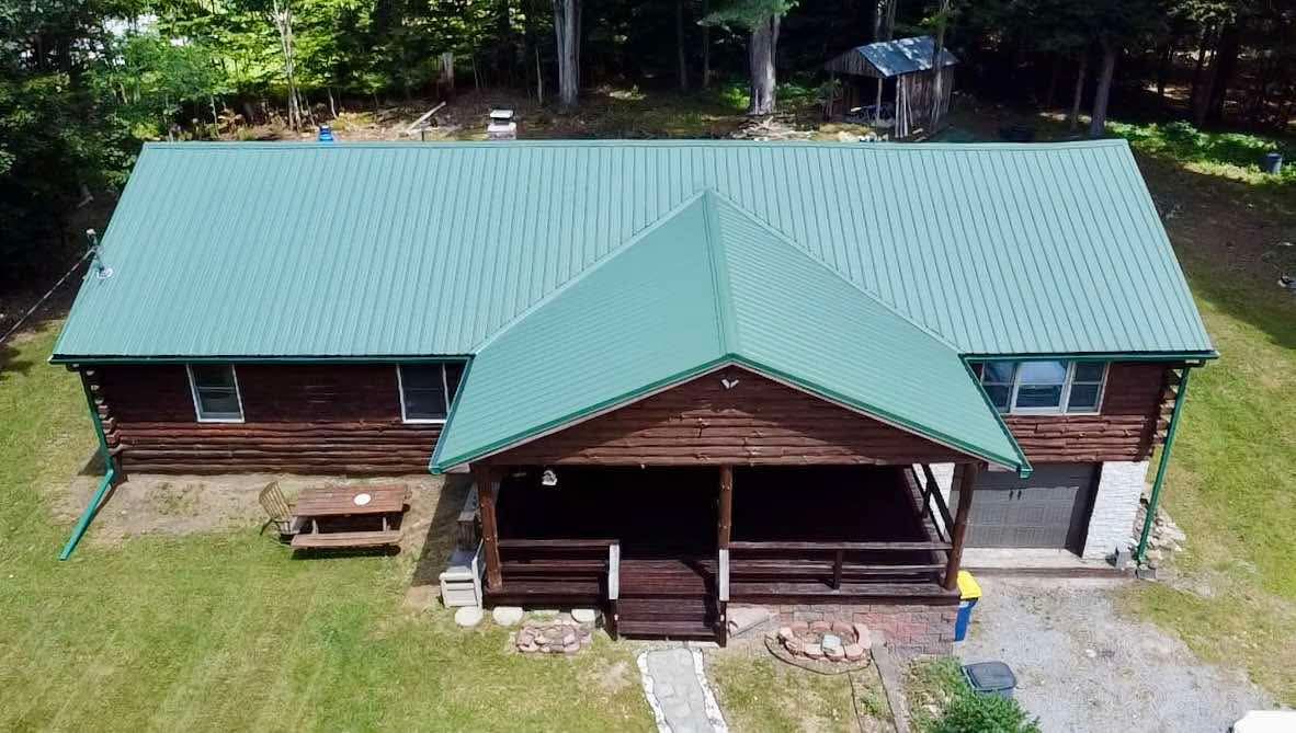 An aerial view of a house with a blue roof