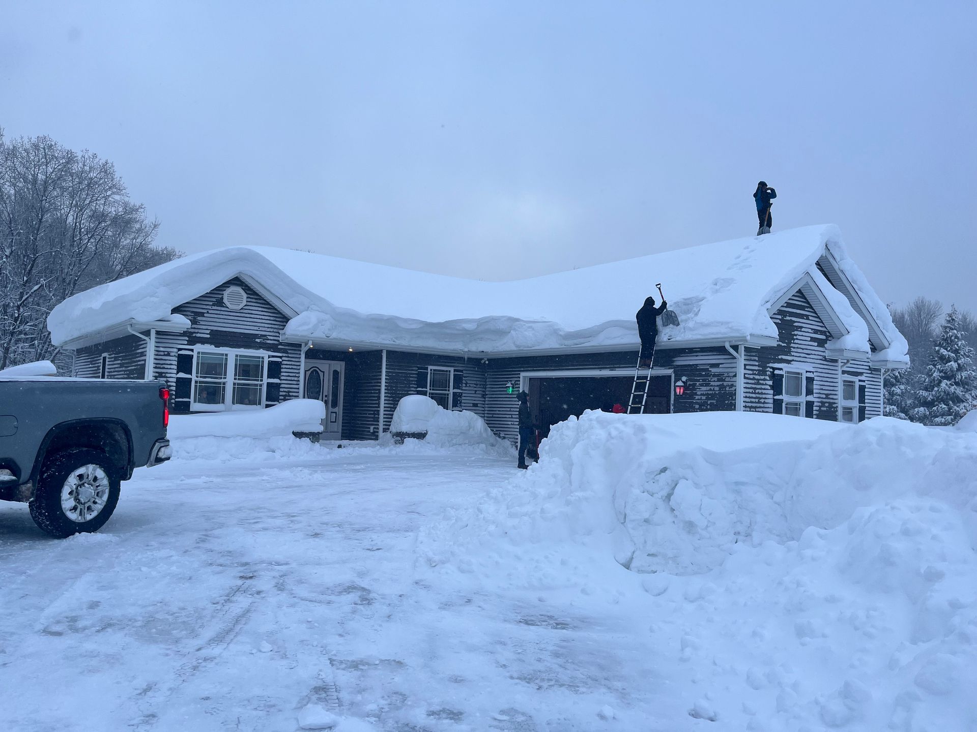 A person is using a snow blower to clear snow from a sidewalk