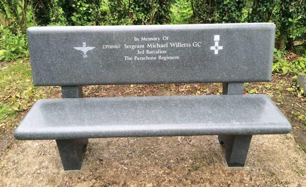 A gray stone bench with a white background
