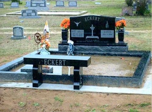 A cemetery with a bench that says ' eckert ' on it