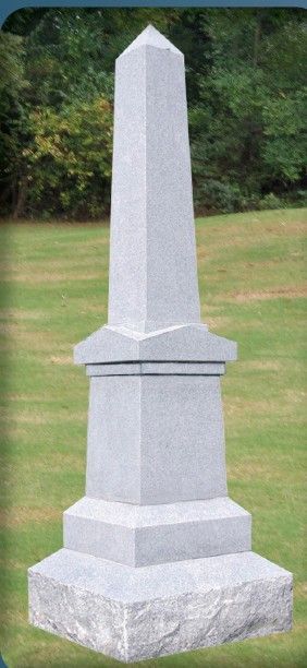 A single white rose is sitting on top of a memorial