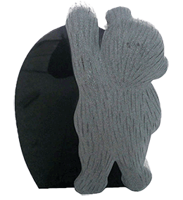 A statue of a bear standing on a black circle