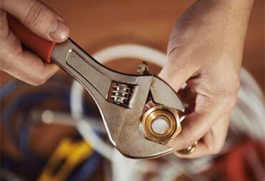 A person wrench over a nut.is holding an adjustable 