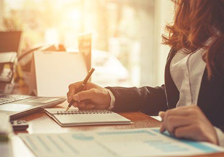 Bookkeeping Services — Woman Writing On A Notebook in Semmes, AL
