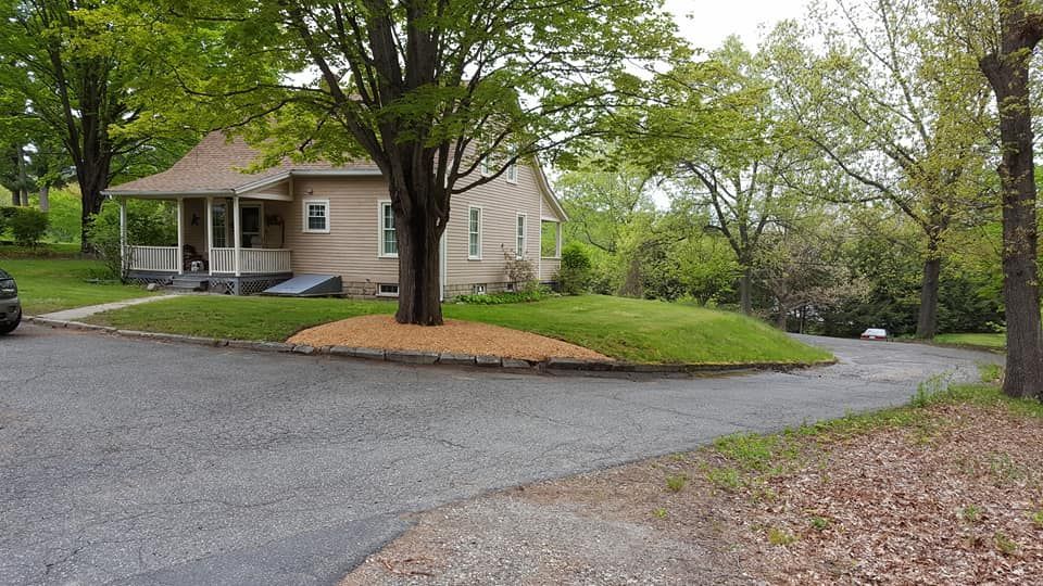 A house with a porch and a car parked in front of it