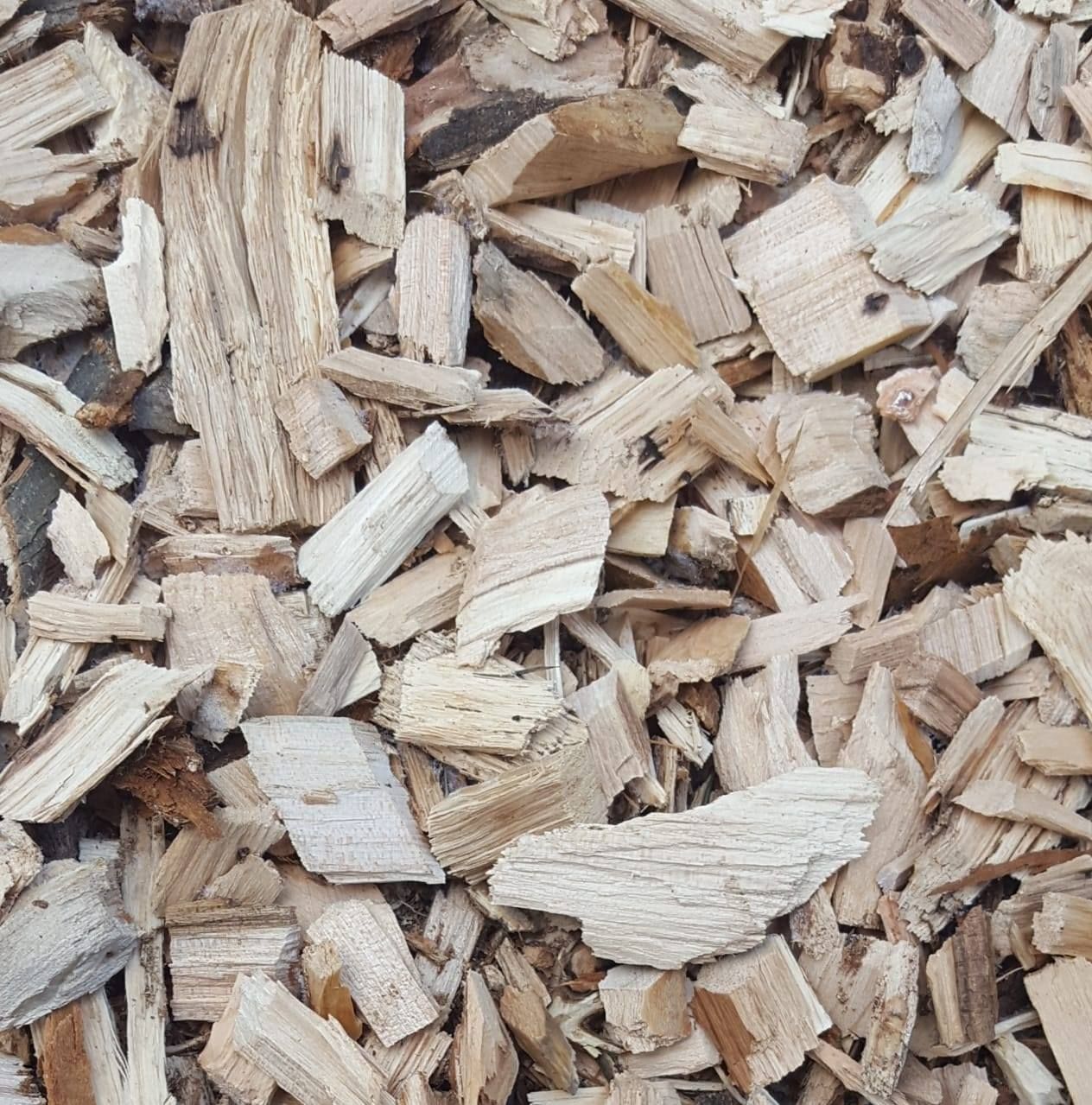 A pile of wood chips is laying on the ground