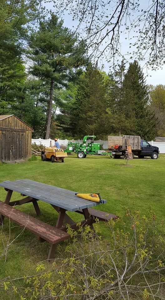 A picnic table is sitting in the middle of a grassy field.