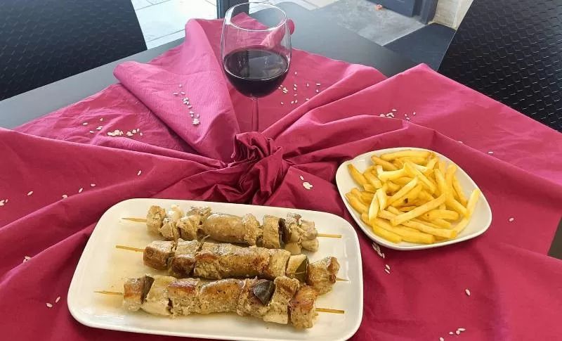 spiedini di carne e contorno di patatine fritte