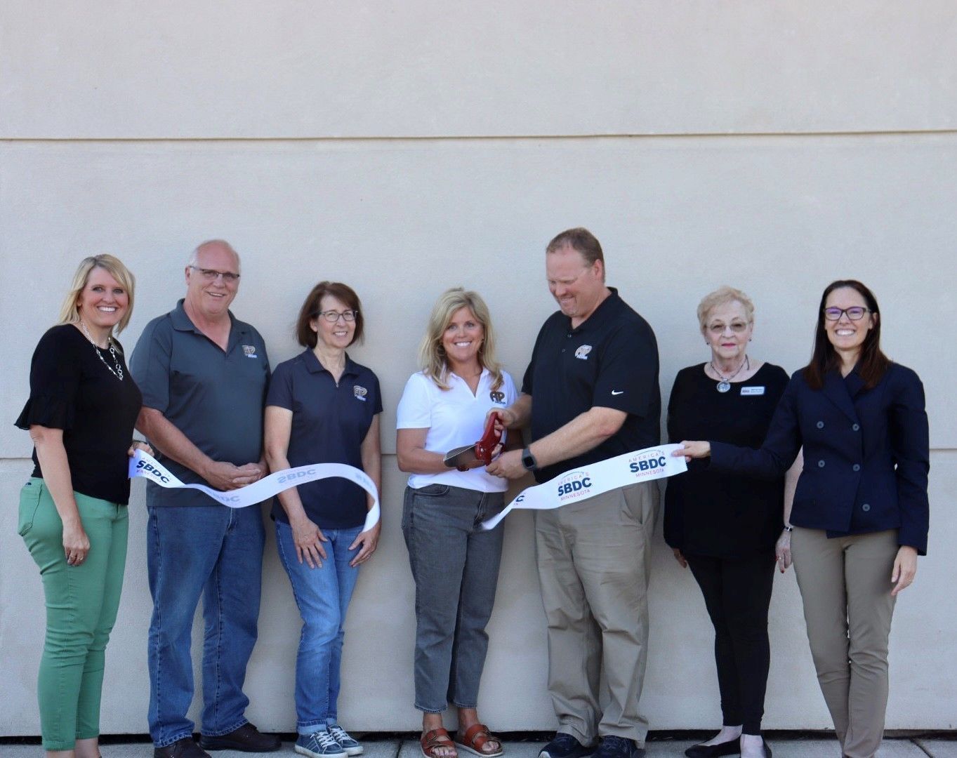 AP Design ribbon cutting with Brian and Nancy Kor, Nick and Jill Schwarz, and representatives of the SBDC.