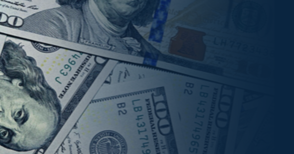 Overlapping US one hundred dollar bills with a dark blue gradient overlay.