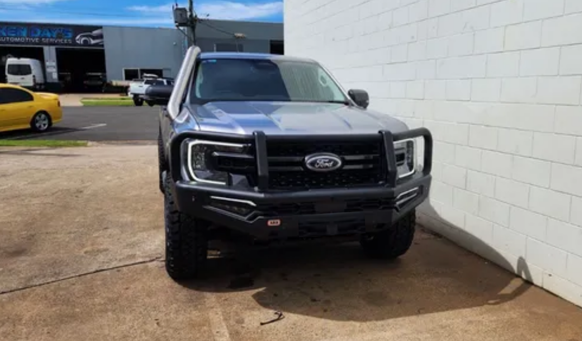A Ford Ranger Pickup Is Parked in Front of A White Brick Wall — Rum City Exhaust Centre in Bundaberg Central, QLD