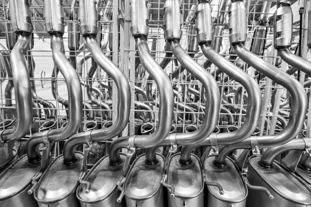 A Black and White Photo of Exhaust Pipes Stacked on Top of Each Other — Rum City Exhaust Centre in Bundaberg Central, QLD