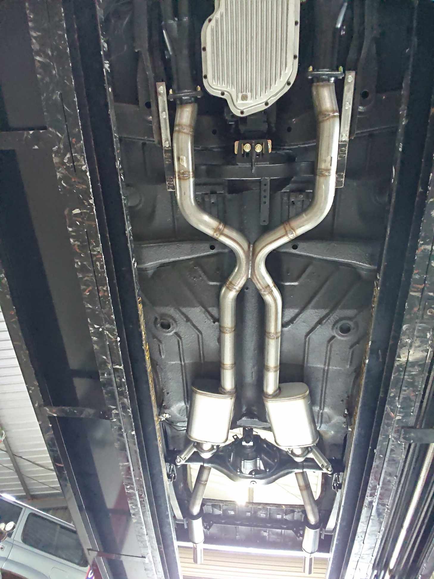 A Close up Of the Underside of A Car with A Exhaust Pipe — Rum City Exhaust Centre in Bundaberg Central, QLD
