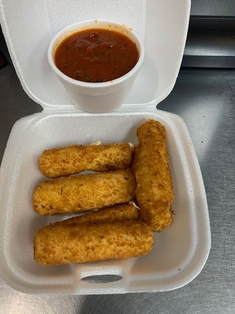 A white foam container holds four fried mozzarella sticks and a side of marinara sauce.